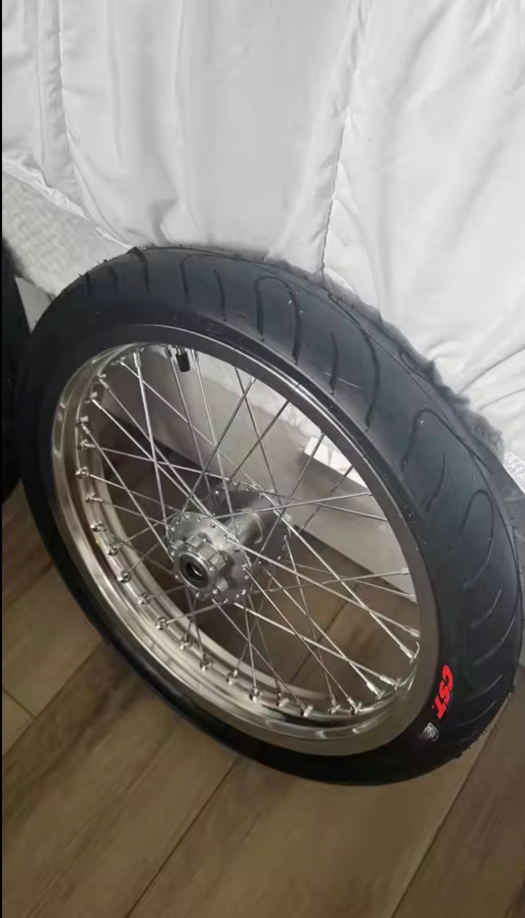 Customer close-up of AMP Racing 17 inch supermoto wheel and CST street tyre